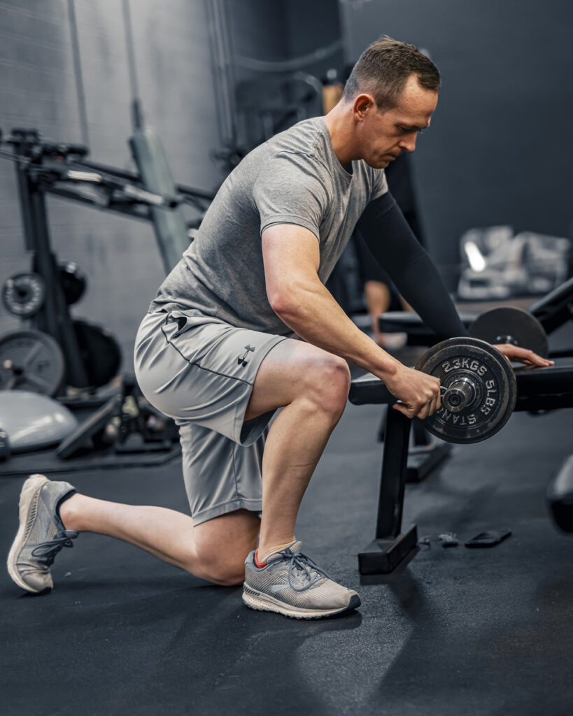 Rex Jones captured in a gym while lifting weights, showcasing commercial photography in Utah with a focus on fitness and active lifestyle.